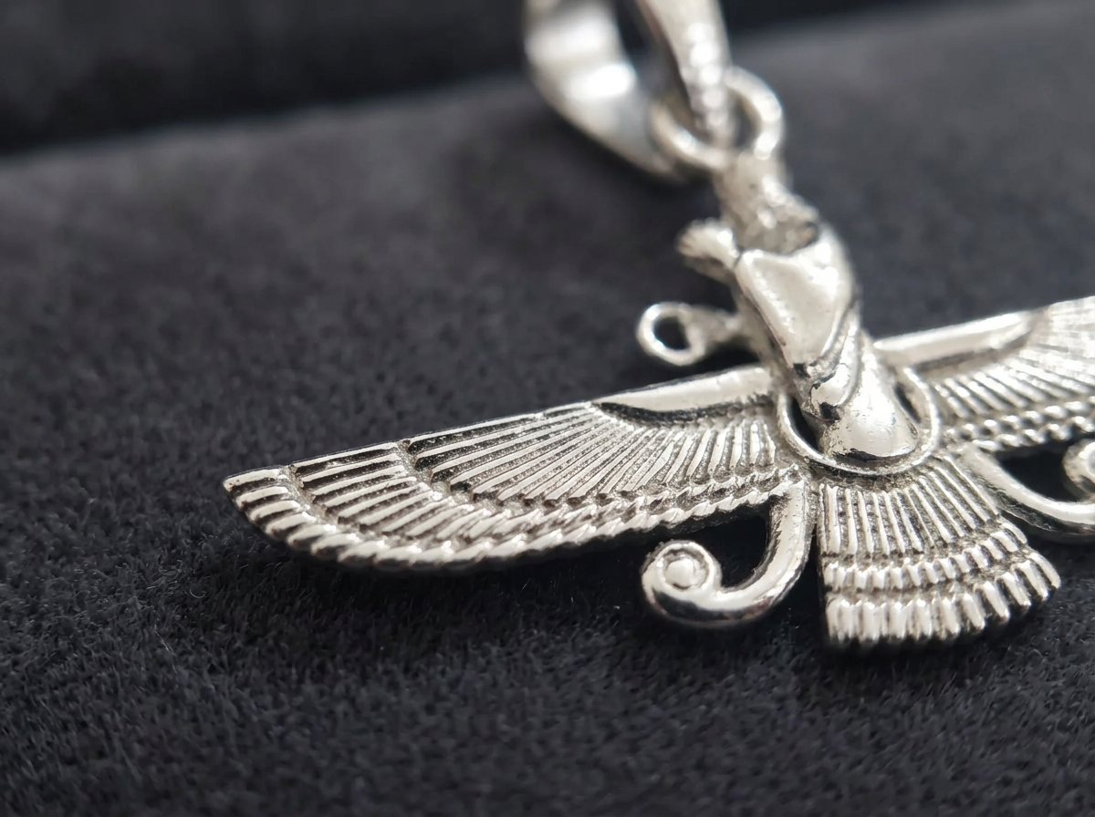 Macro detail of The Eternal Asho Farohar 3D 360 pendant showing feather texture